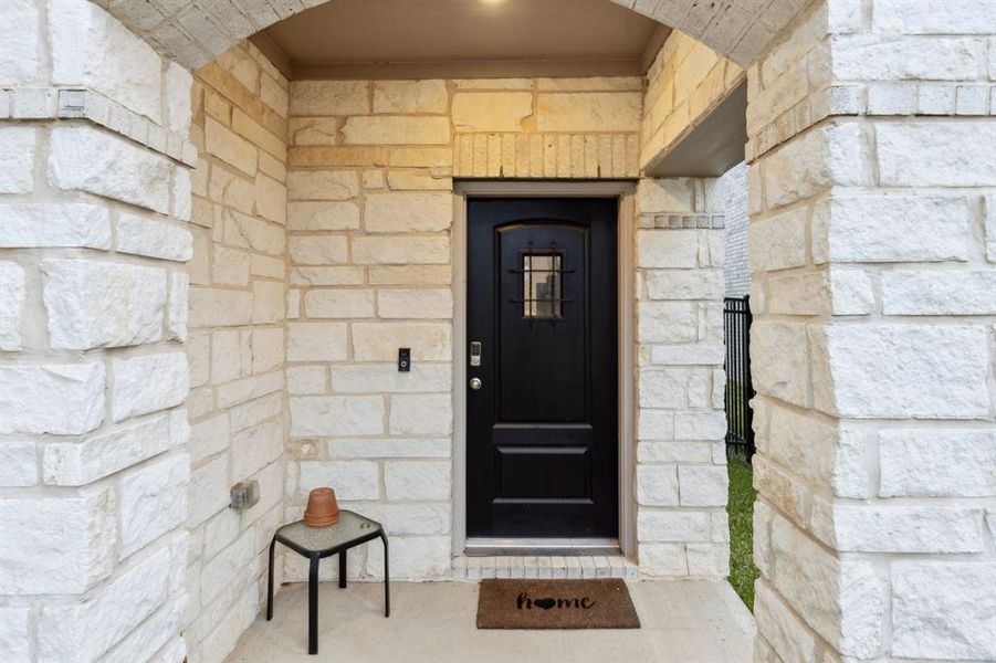 Enjoy the picturesque stone front porch as you enter the beautiful home.