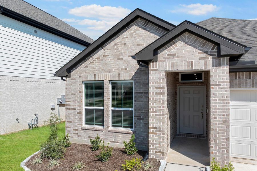 Eye-catching curb appeal with a stylish exterior and neatly landscaped front lawn