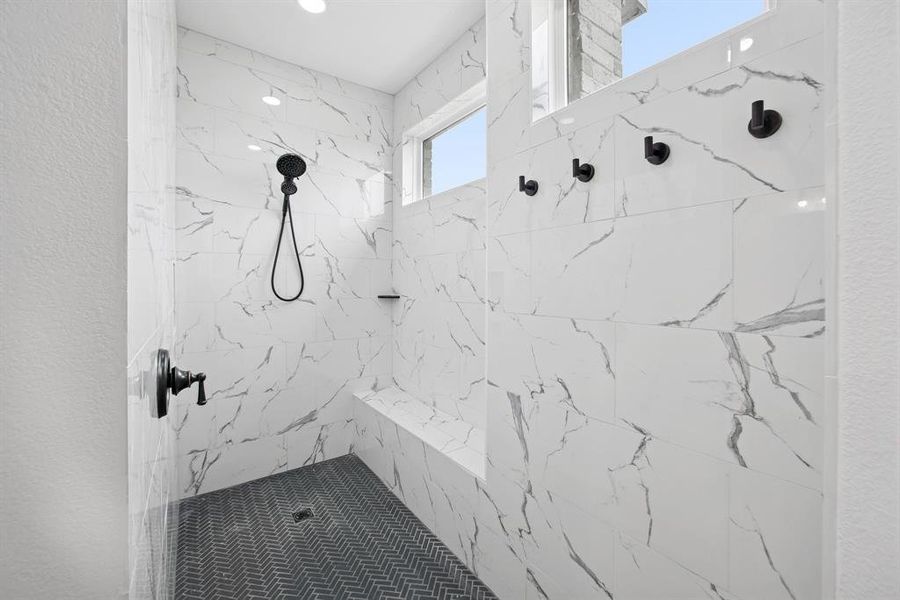 Full bath featuring a marble finish shower