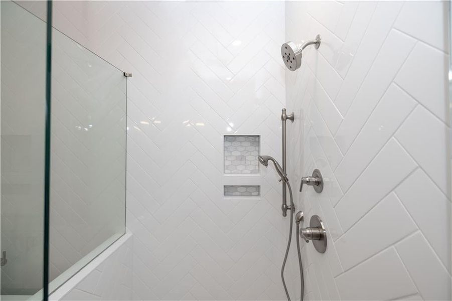 Bathroom featuring a tile shower