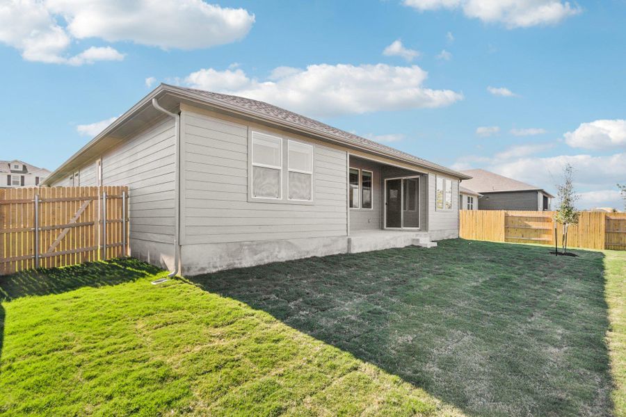 Rear view of house featuring a fenced backyard and a patio