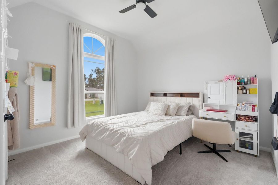 Elegant secondary bedroom with abundant natural light.