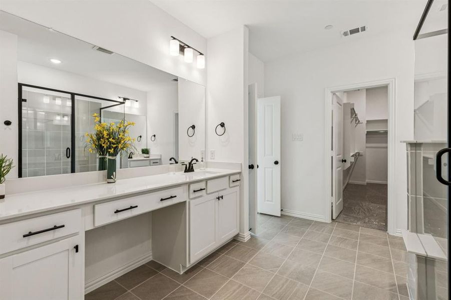 Separate vanities offers everyone their own space in the gorgeous owner's bath.
