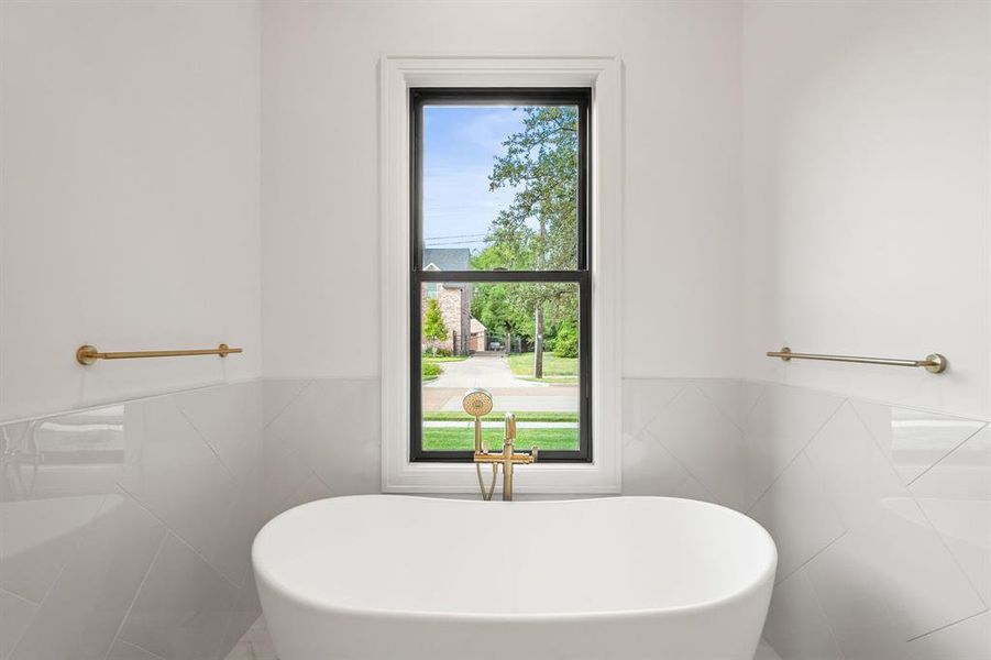 Mast Bathroom with a freestanding bath, tile walls, and wainscoting Mast Bathroom with a freestanding bath, tile walls, and wainscoting