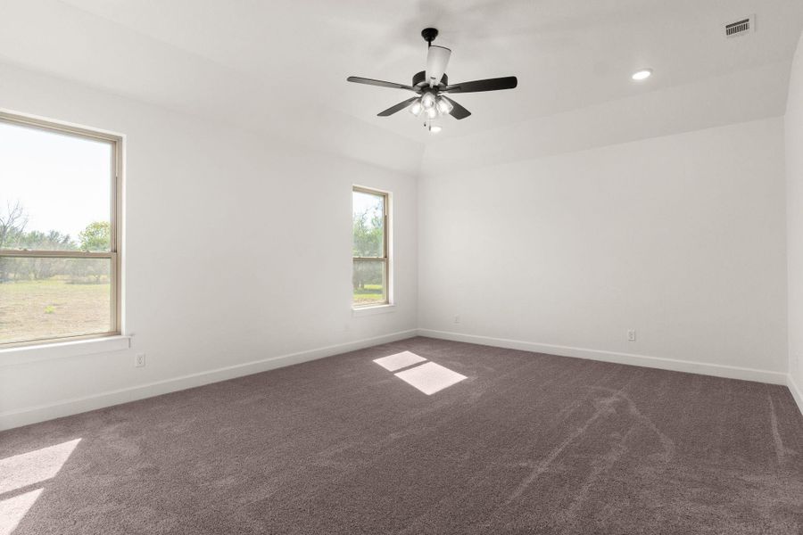 Spare room with dark carpet, recessed lighting, and ceiling fan