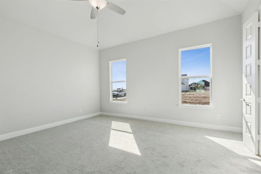 Spare room with light carpet and ceiling fan