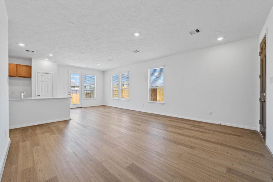 Stunning open-concept design seamlessly connecting the living, dining, and kitchen areas—perfect for both everyday living and entertaining!