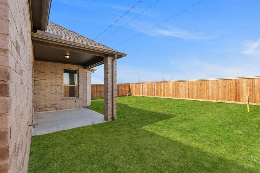 The covered patio is generously sized, providing ample space for various outdoor activities.