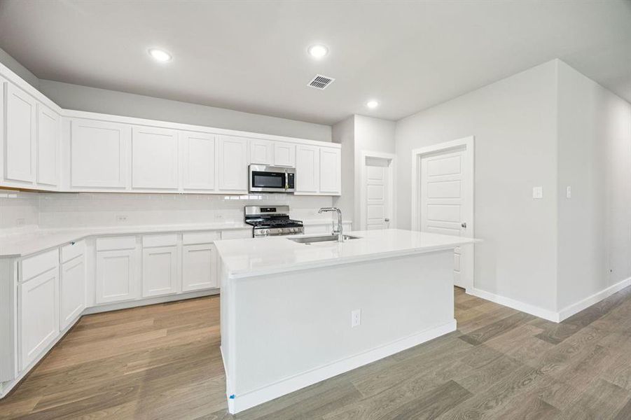Kitchen in the Hayden home plan by Trophy Signature Homes – REPRESENTATIVE PHOTO