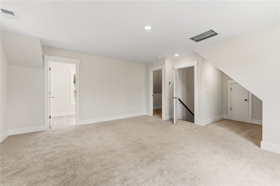 A spacious, naturally illuminated room featuring p