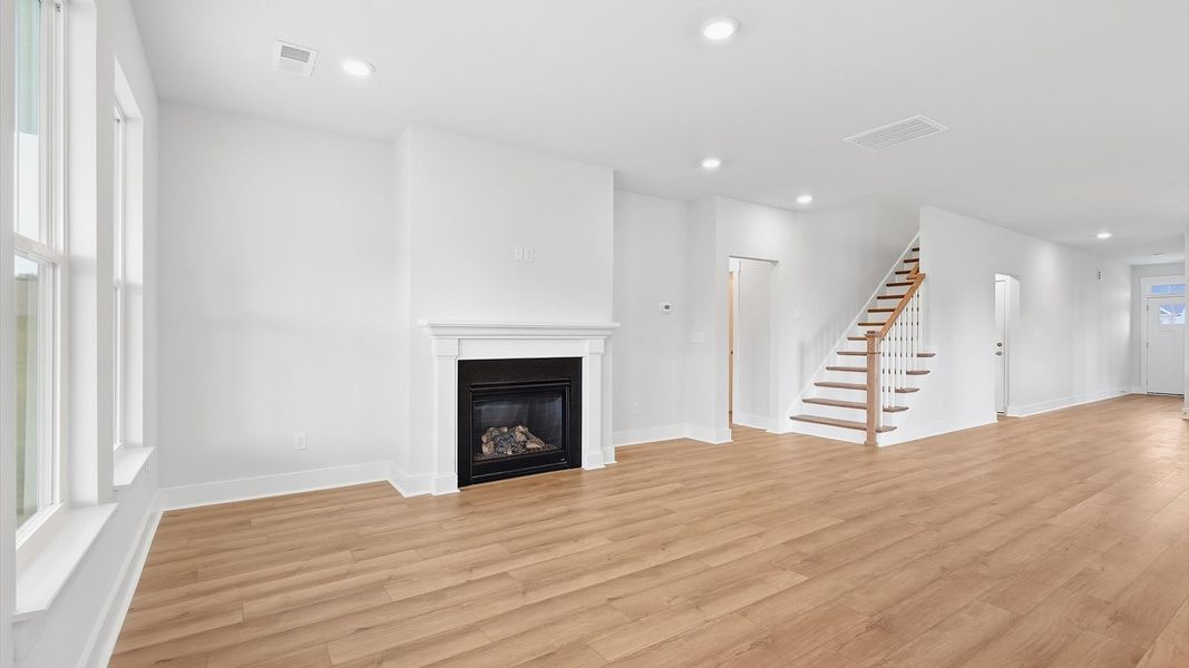 Hardwood flooring and high standards define this vibrant family room ideal for everyday living