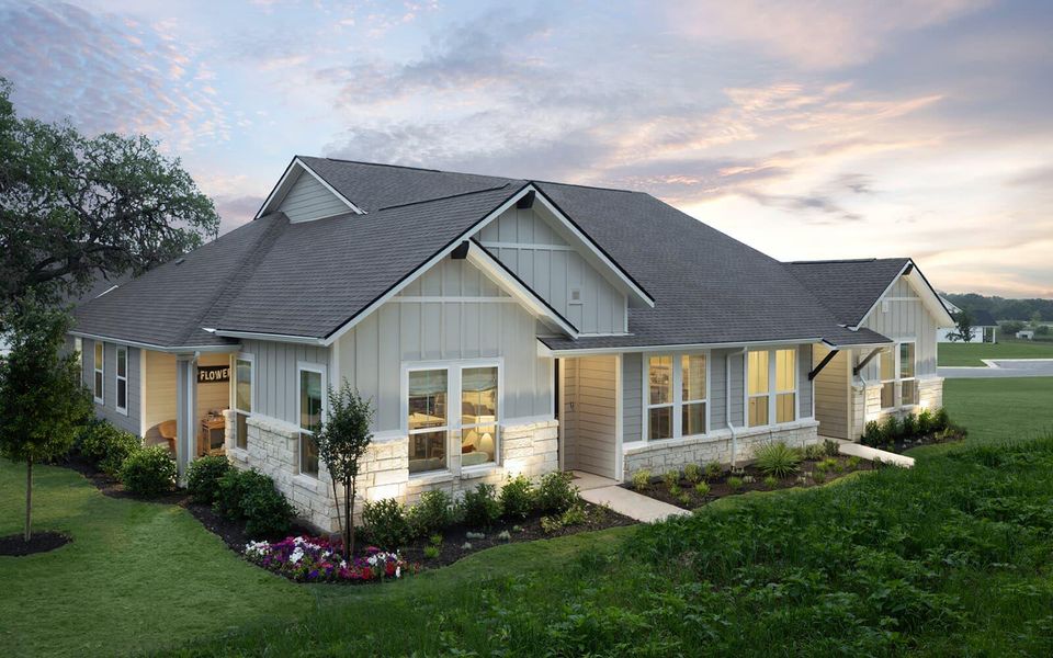 View of front of home with stone siding, board and batten siding, and a front yard