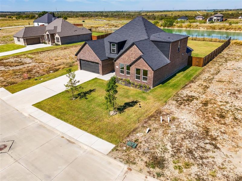 Front exterior of a new home in , Venus, TX, highlighting curb appeal (Image 24).