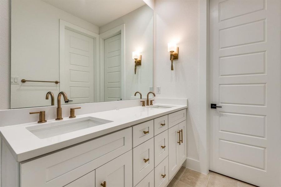 Bathroom featuring tile patterned flooring and vanity