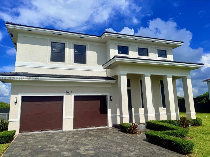 Front exterior of a new home in , Homestead, FL, highlighting curb appeal (Image 20). Front exterior of a new home in , Homestead, FL, highlighting curb appeal (Image 20).