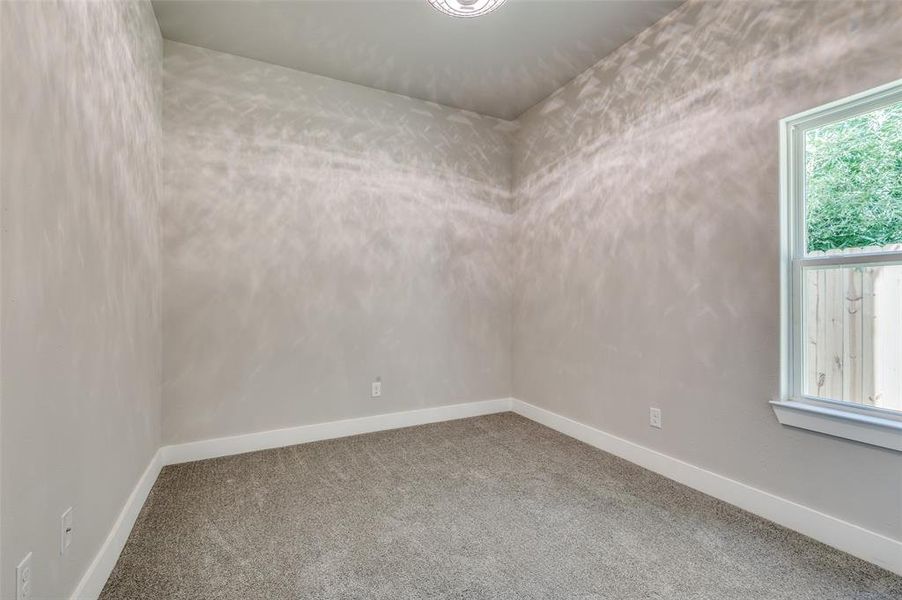 Carpeted spare room with baseboards Carpeted spare room with baseboards