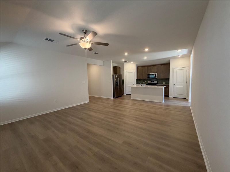 Unfurnished living room with recessed lighting, dark wood-type flooring, and ceiling fan Unfurnished living room with recessed lighting, dark wood-type flooring, and ceiling fan