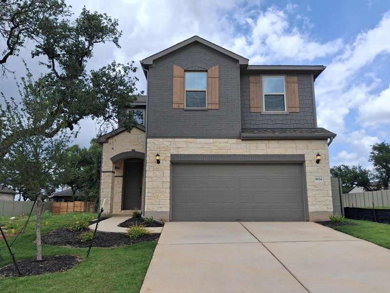 Front exterior of a new home in Wolf Ranch, Georgetown, TX, highlighting curb appeal (Image 1). Front exterior of a new home in Wolf Ranch, Georgetown, TX, highlighting curb appeal (Image 1).