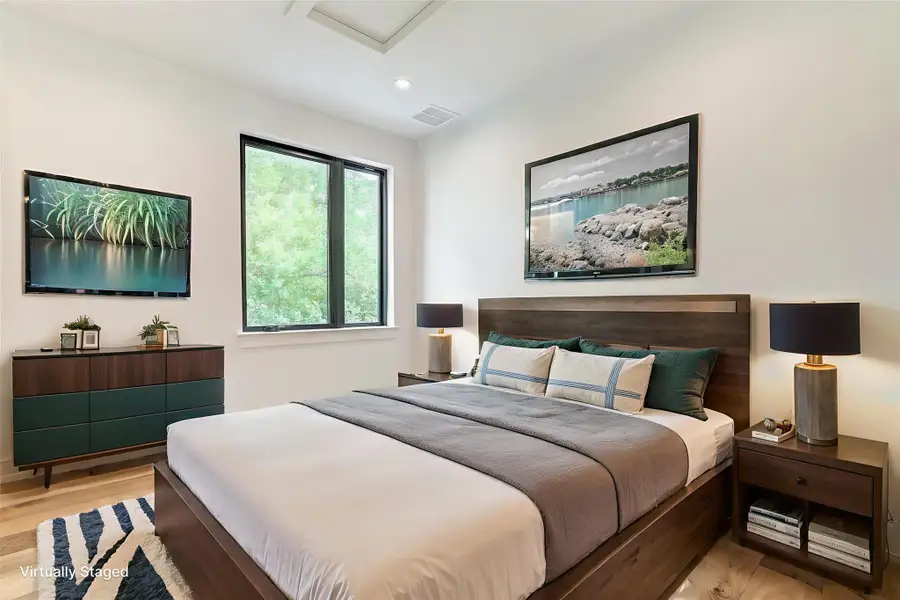 Bedroom with light wood-style floors, attic access, and recessed lighting