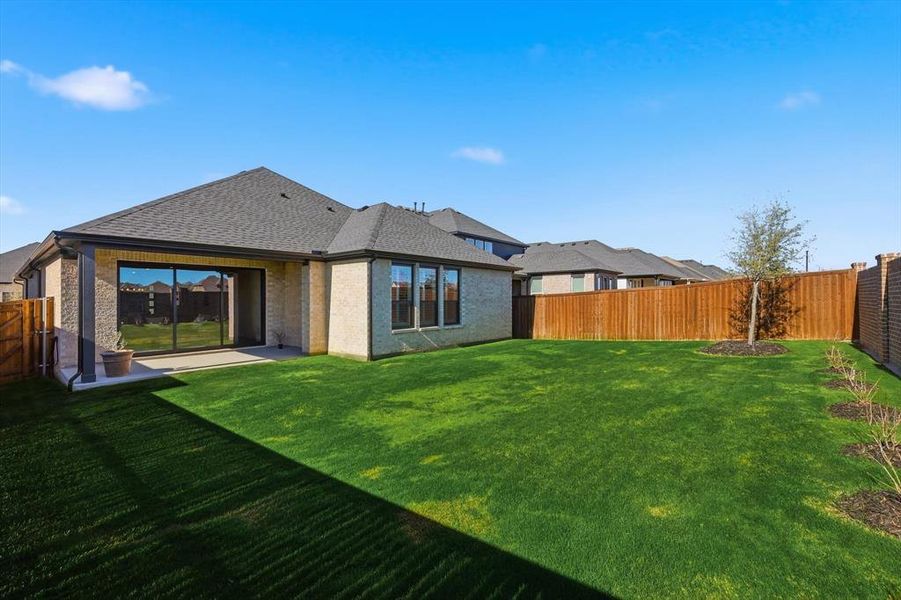 Back of house with a fenced backyard, a patio area, brick siding, and a shingled roof