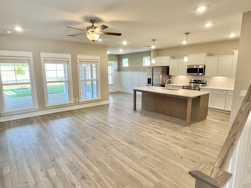 Stock. View of great room, kitchen and dining area
