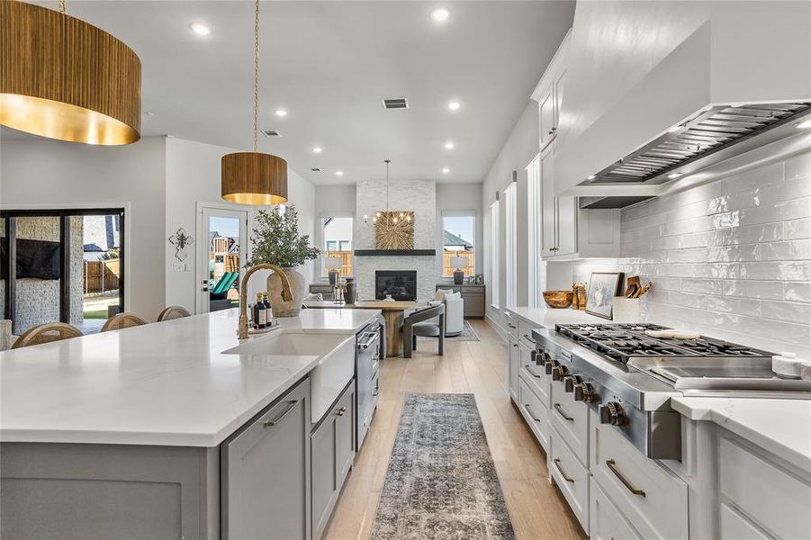 Luxury apron front farm sink, gas stovetop with griddle, custom backsplash and hardware... a chef's dream kitchen