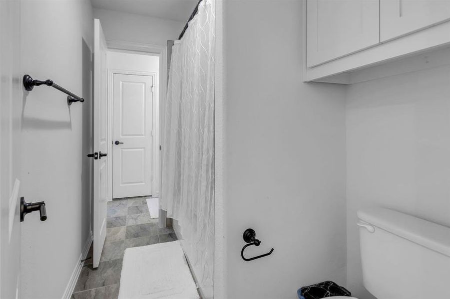 Bathroom featuring tile patterned flooring and toilet