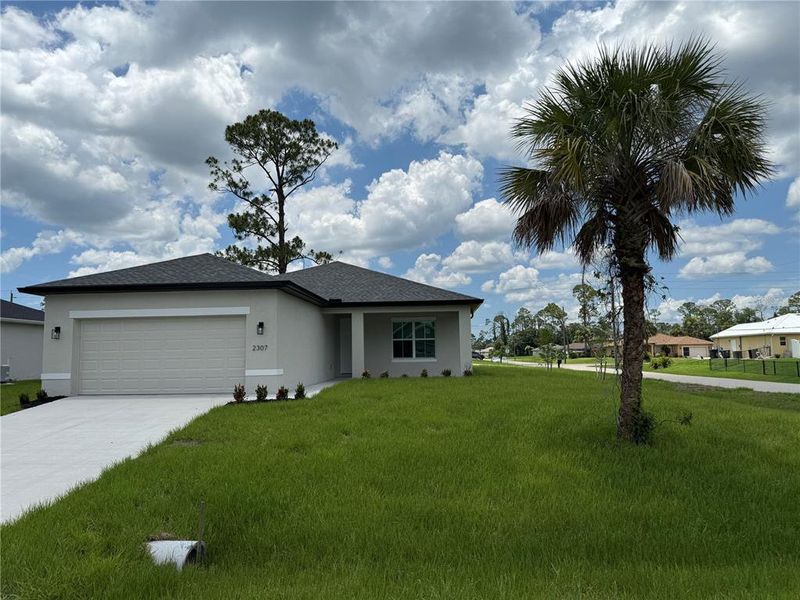 Front exterior of a new home in , North Port, FL, highlighting curb appeal (Image 2). Front exterior of a new home in , North Port, FL, highlighting curb appeal (Image 2).