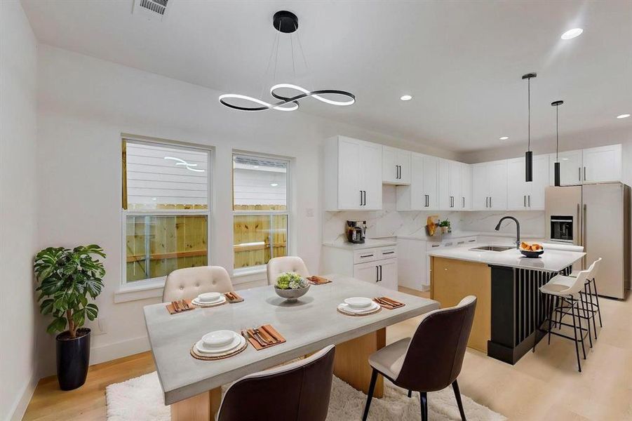 Dining space with light wood finished floors and recessed lighting Dining space with light wood finished floors and recessed lighting