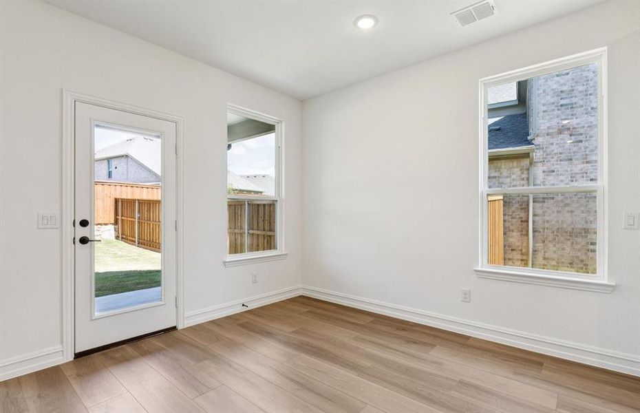 Dining nook off kitchen with large windows