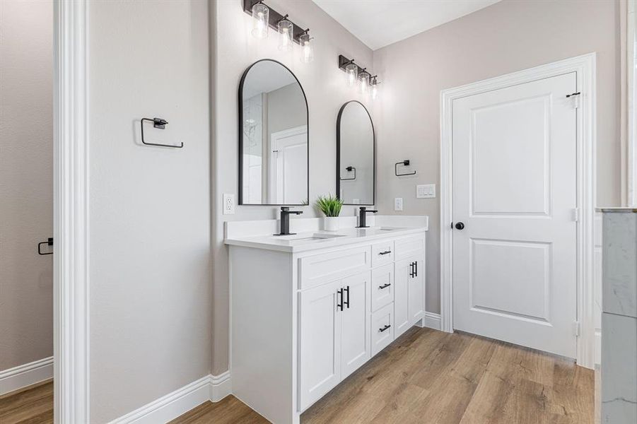 Bathroom featuring vanity and wood-type flooring