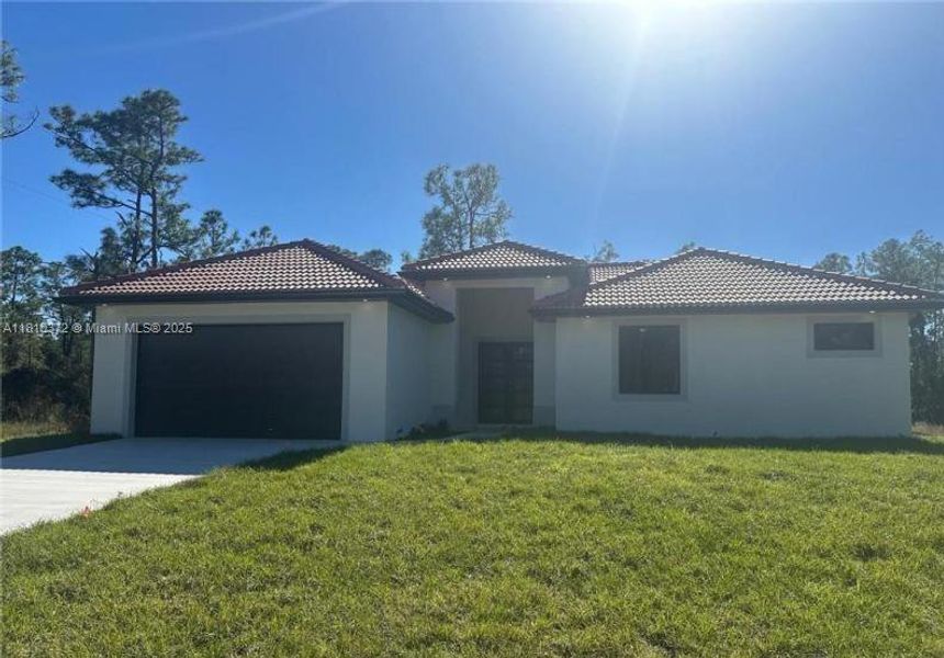 Front exterior of a new home in , Lehigh Acres, FL, highlighting curb appeal (Image 8). Front exterior of a new home in , Lehigh Acres, FL, highlighting curb appeal (Image 8).