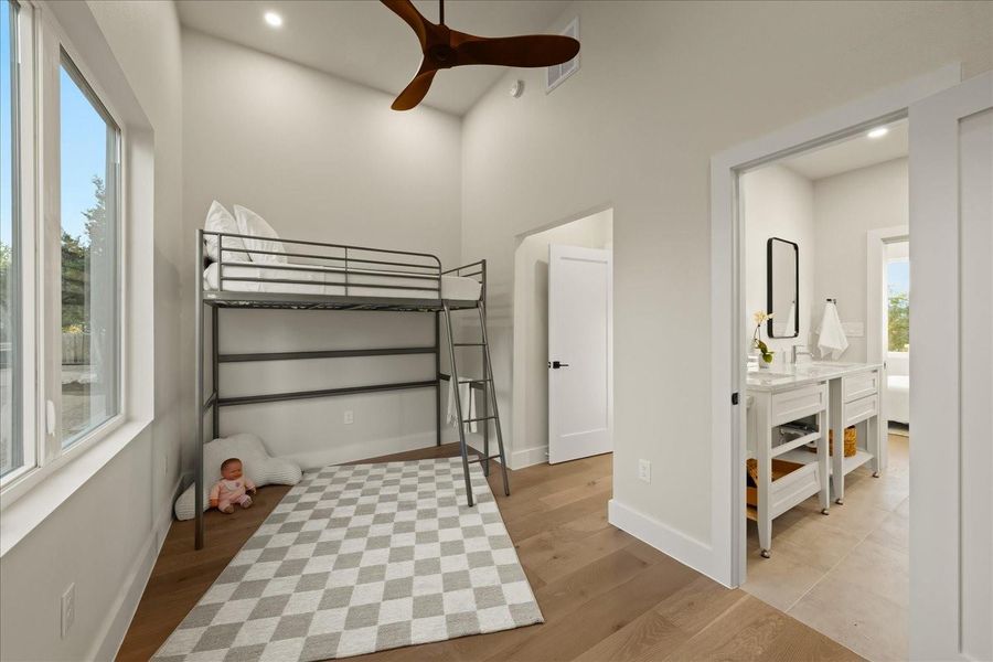 Main house, first level: Secondary bedroom with view of connecting bath. This bedroom also has a laundry closet.