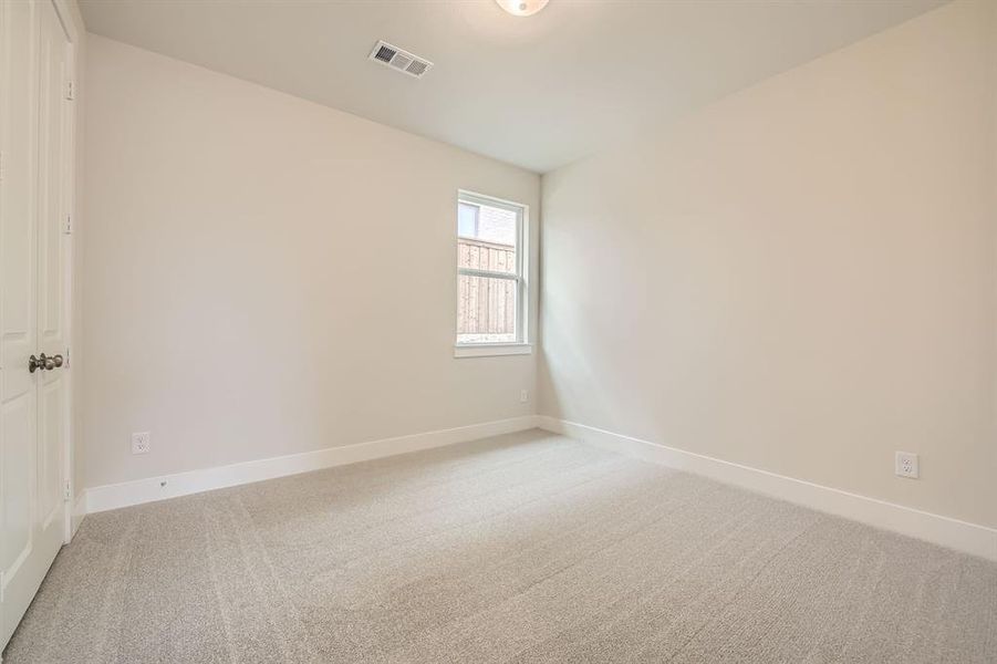 Spare room featuring light colored carpet