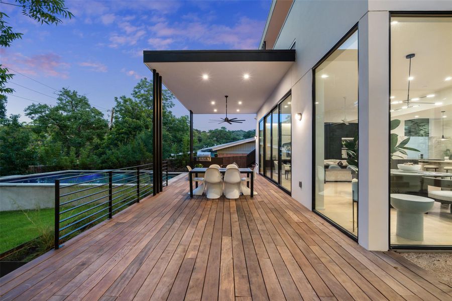 Wooden terrace with ceiling fan, an outdoor pool, and outdoor dining space Wooden terrace with ceiling fan, an outdoor pool, and outdoor dining space