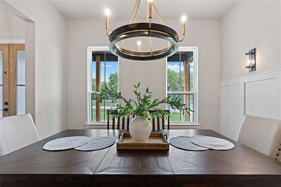 Dining space with a wealth of natural light and an inviting chandelier