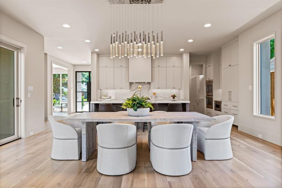 Dining area with light wood-style floors and recessed lighting Dining area with light wood-style floors and recessed lighting
