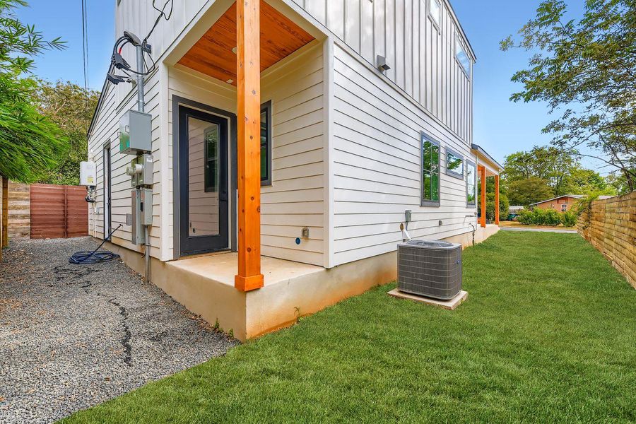 View of side of home with a fenced backyard and board and batten siding View of side of home with a fenced backyard and board and batten siding