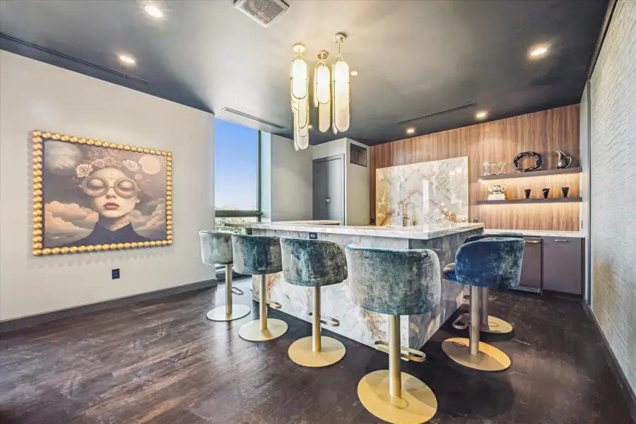 The sleek kitchen viewed in the background offers everything needed for entertaining. The room can be reserved for gatherings. The sleek kitchen viewed in the background offers everything needed for entertaining. The room can be reserved for gatherings.