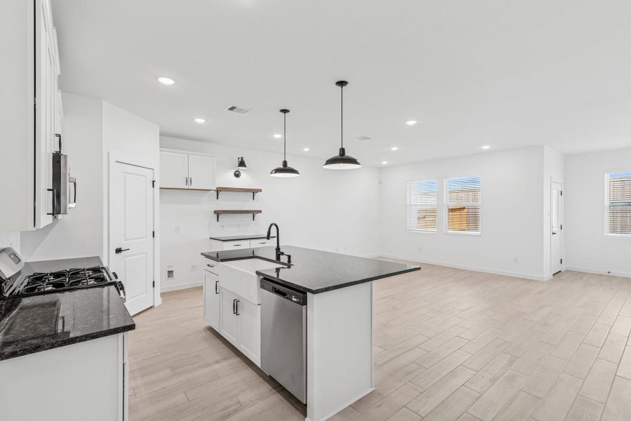 Lovely kitchen with granite counters and floating shelves Lovely kitchen with granite counters and floating shelves