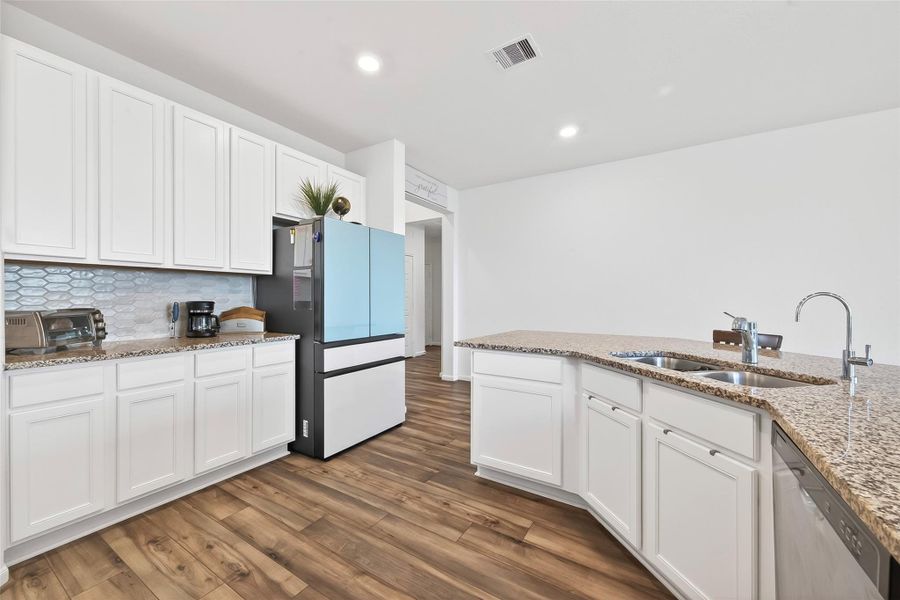 White cabinets offer a light and bright feel to the kitchen