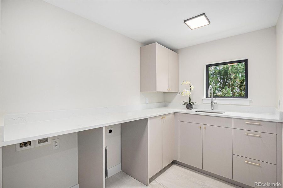 Laundry room attached to the primary suite closet