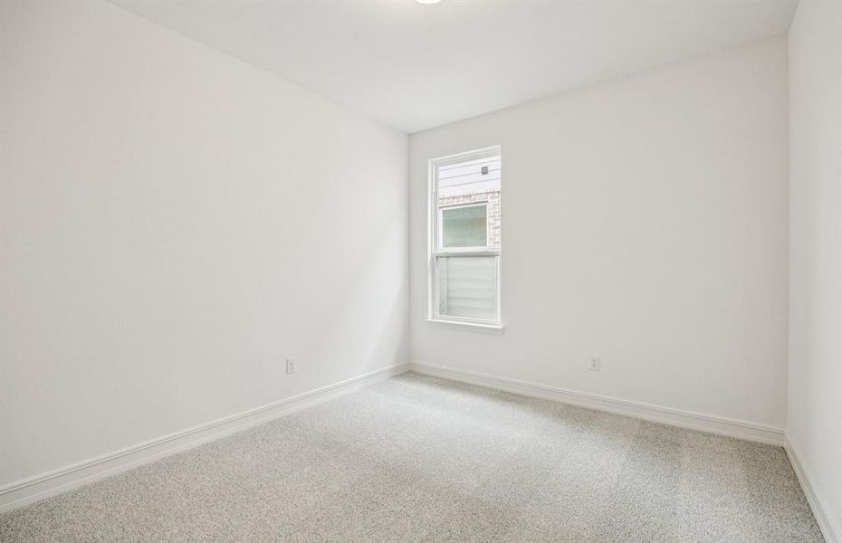 Comfortable secondary bedroom with generous closet space *Real home pictured