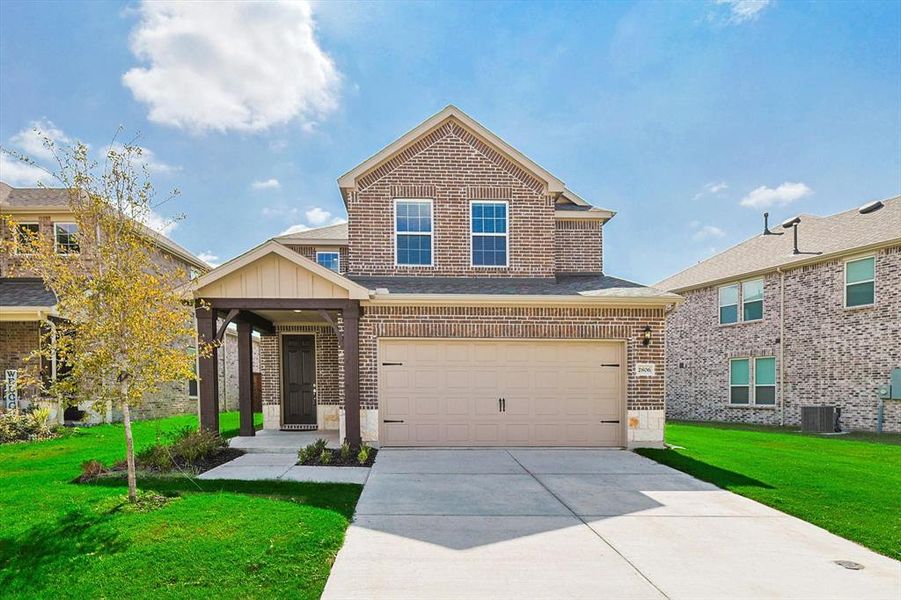 Craftsman-style home with a front yard, a garage, and cooling unit