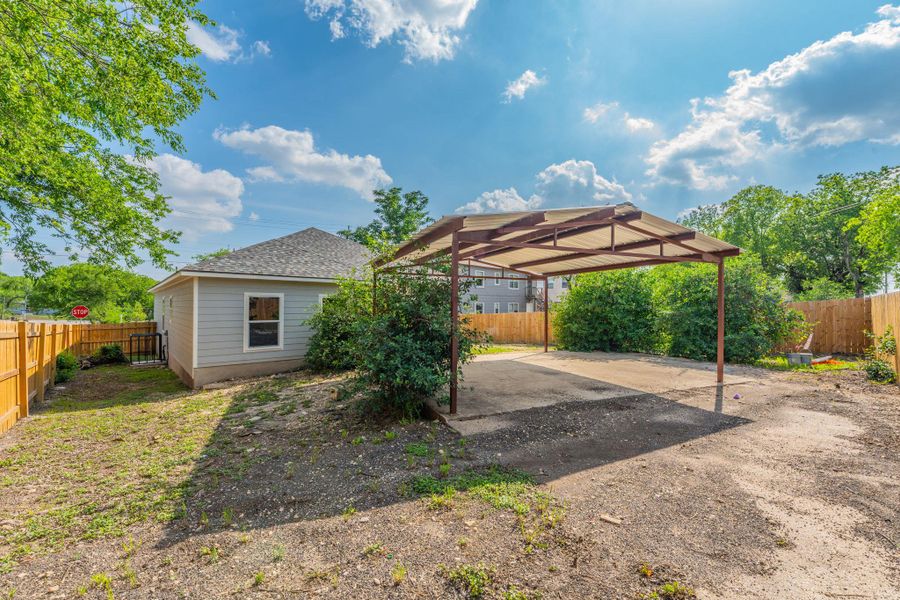 Freestanding carport with a concrete pad and metal frame