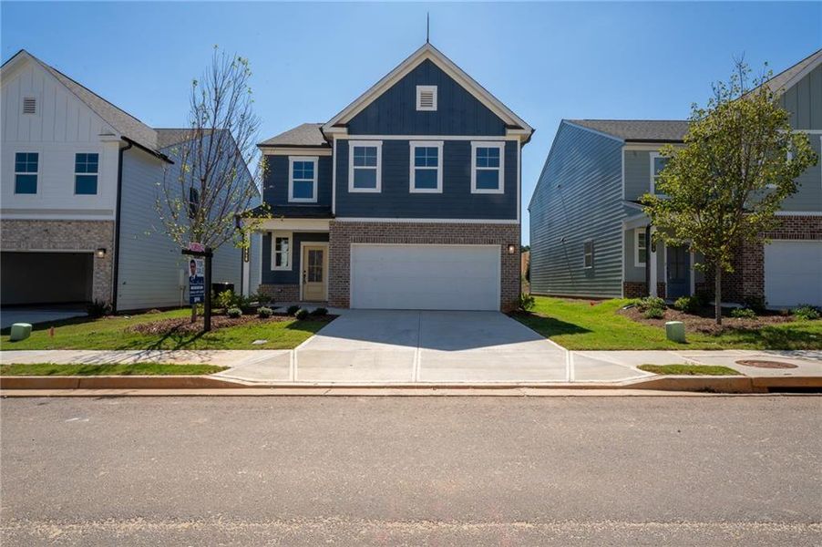 Front exterior of a new home in Annsbury Park, Lilburn, GA, highlighting curb appeal (Image 20). Front exterior of a new home in Annsbury Park, Lilburn, GA, highlighting curb appeal (Image 20).