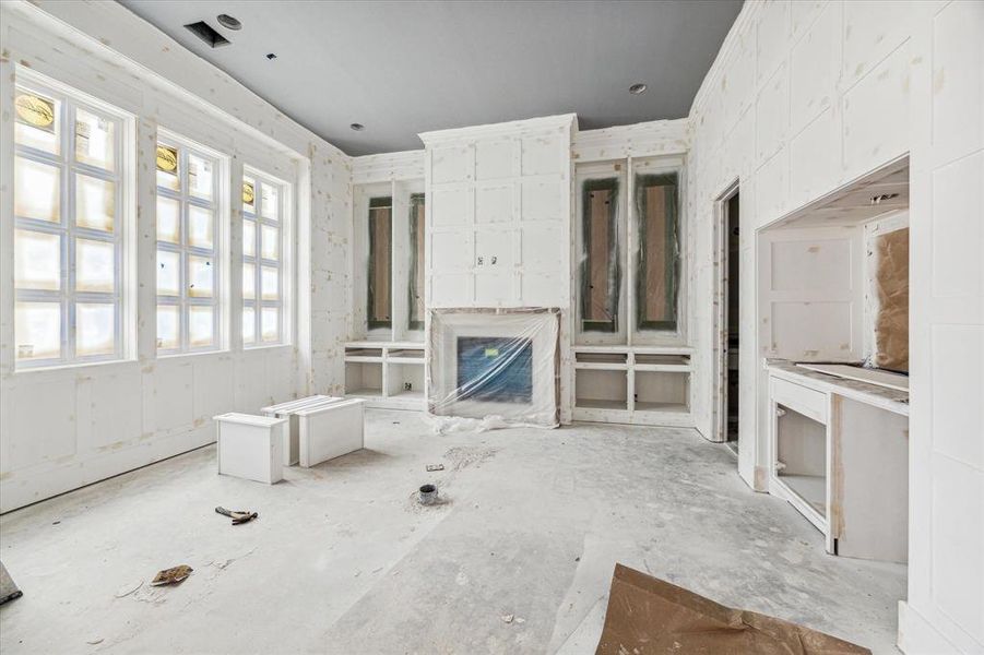 First floor study with cast-stone surround fireplace,  wet bar and stunning architectural details.  Construction as of 10/29