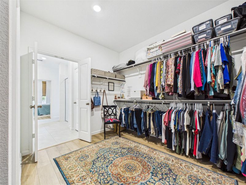 This oversized primary suite closet connects to the bathroom and also the laundry room! This makes laundry so much easier!