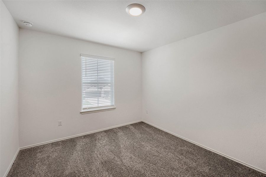 Bedroom #3 with white walls, window with horizontal blinds, and a ceiling-mounted light fixture Bedroom #3 with white walls, window with horizontal blinds, and a ceiling-mounted light fixture