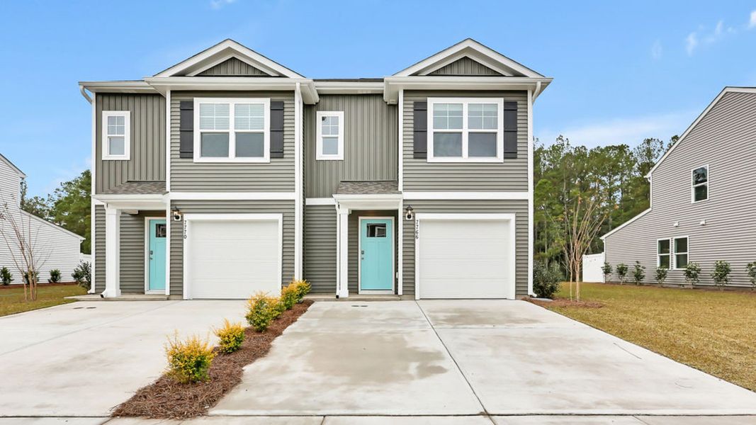 Front exterior of a new home in Grayson Park Duets, Leland, NC, highlighting curb appeal (Image 1).